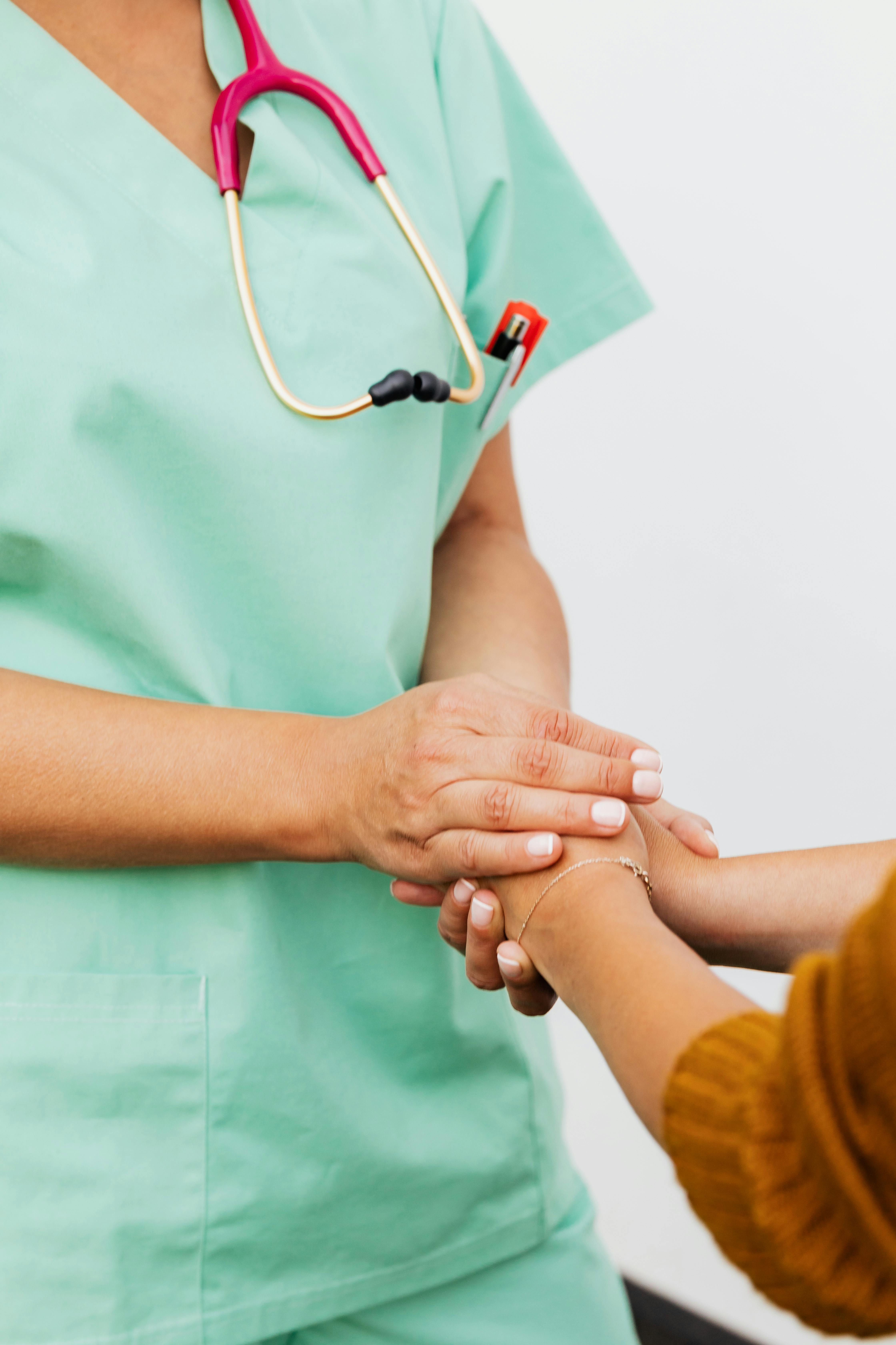 Pharmacist holding hands with a patient